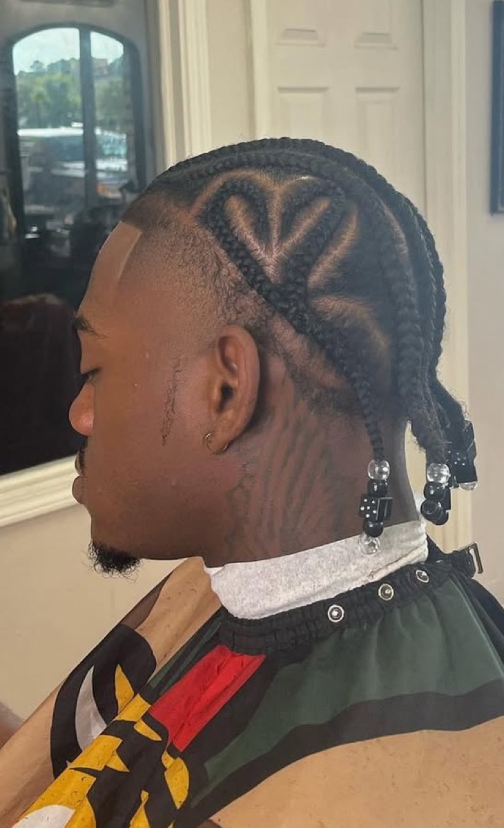 Detailed cornrow braid design with a heart part and clean line-up