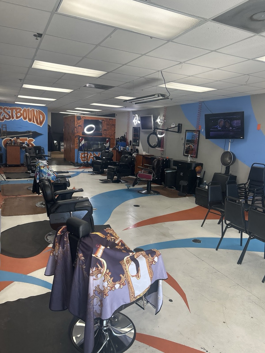 Inside Westbound — barber chairs, mural and big-screen TV